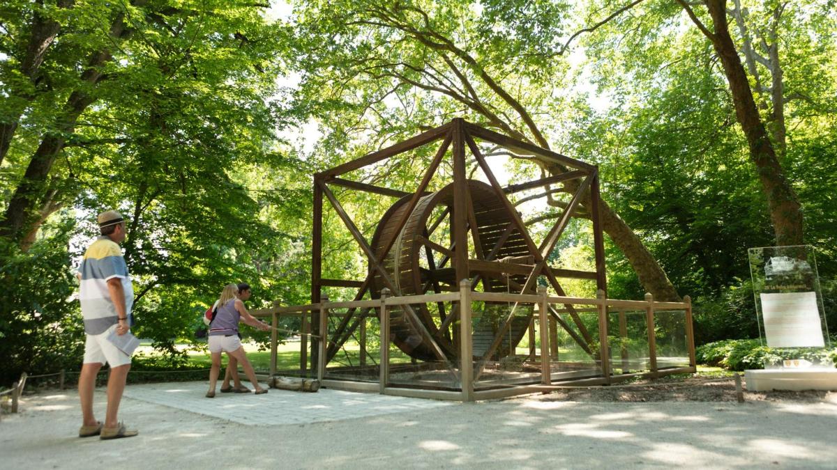 a man and a woman standing next to a metal structure