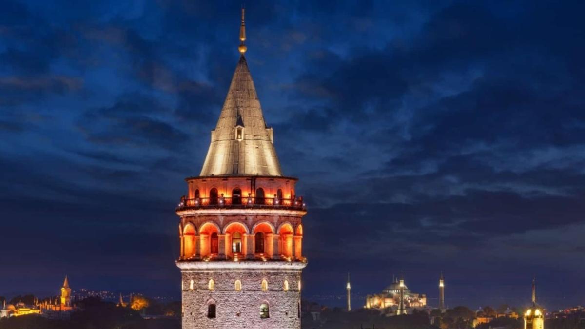 a tall clock tower with a steeple at night