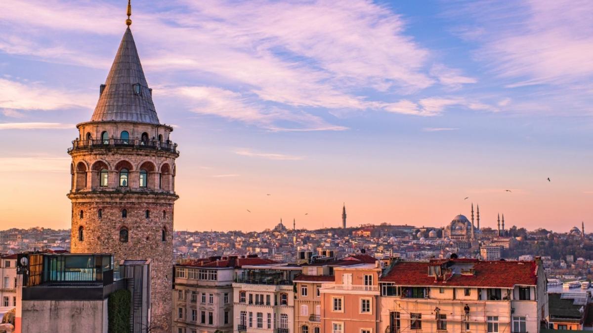 a tall tower with a steeple on top of a city