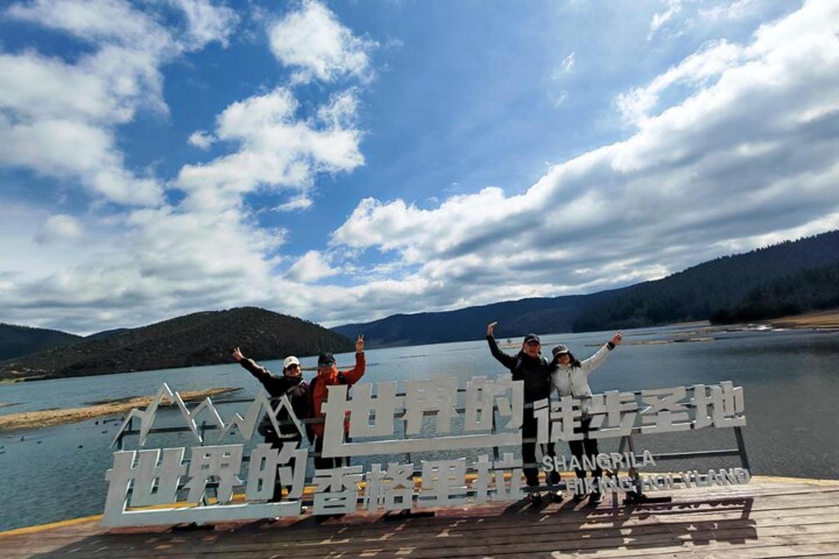 a group of people standing on a boat on a lake