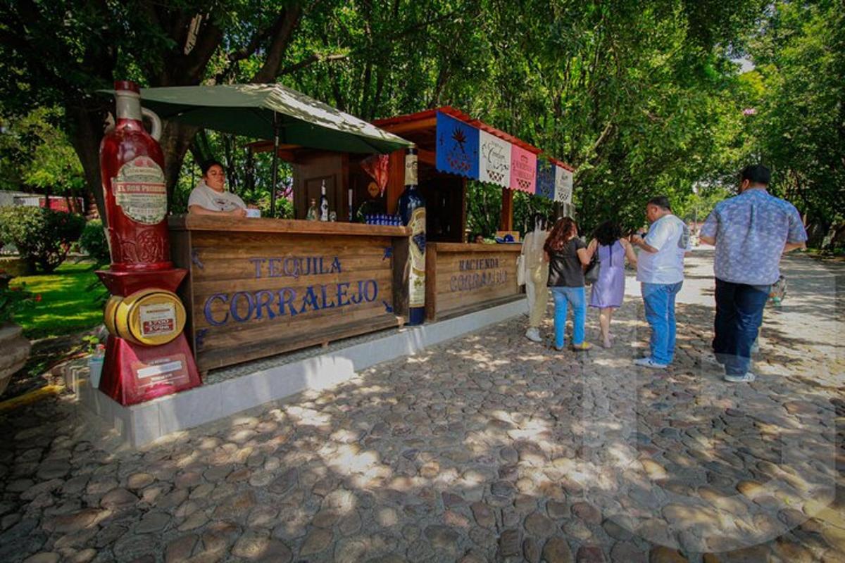a group of people standing around a bar with a ketchup bottle