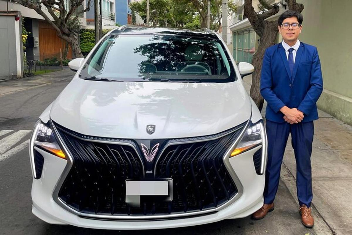 a man in a suit standing next to a car