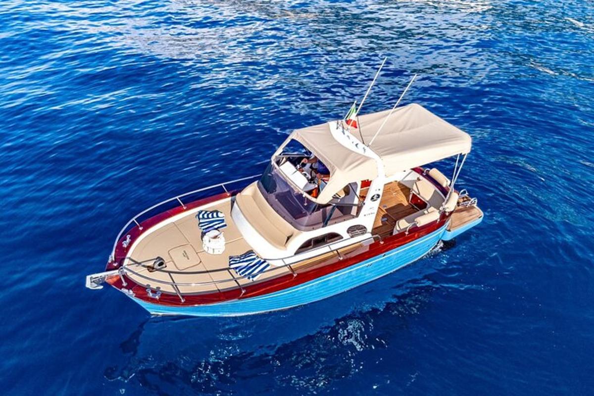 a small boat floating in the blue water