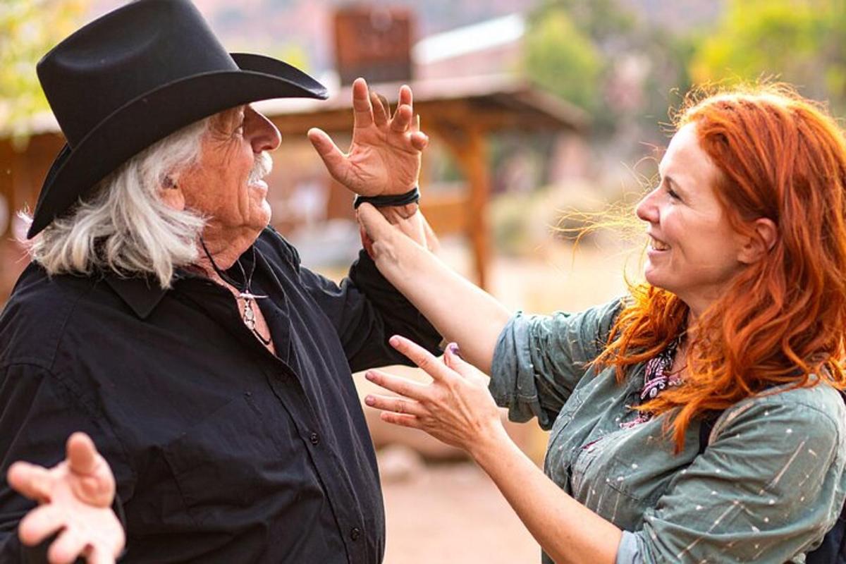 a woman standing next to a man in a top hat