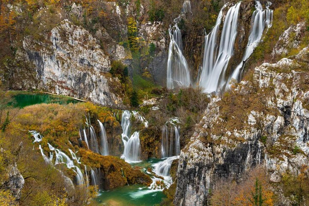 an aerial view of waterfalls in a forest