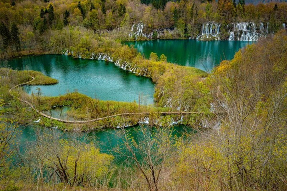an aerial view of a lake with a waterfall