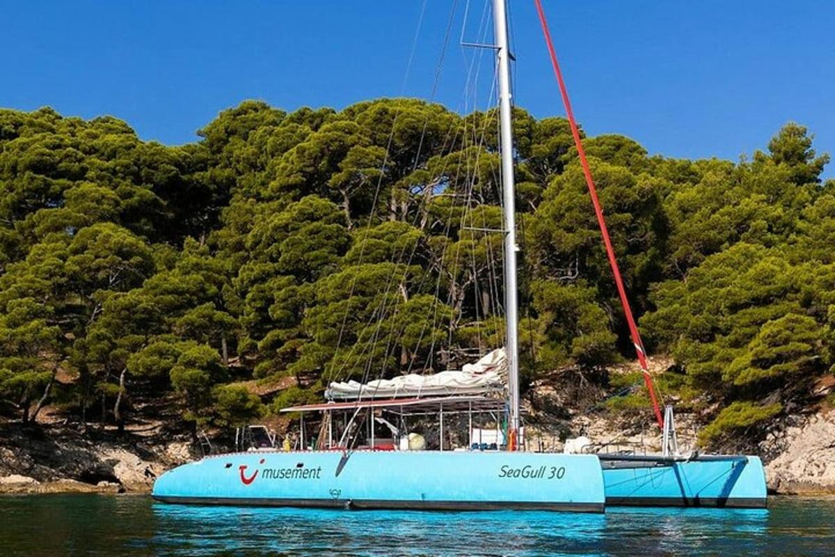 una barca blu seduta nell'acqua accanto a una montagna