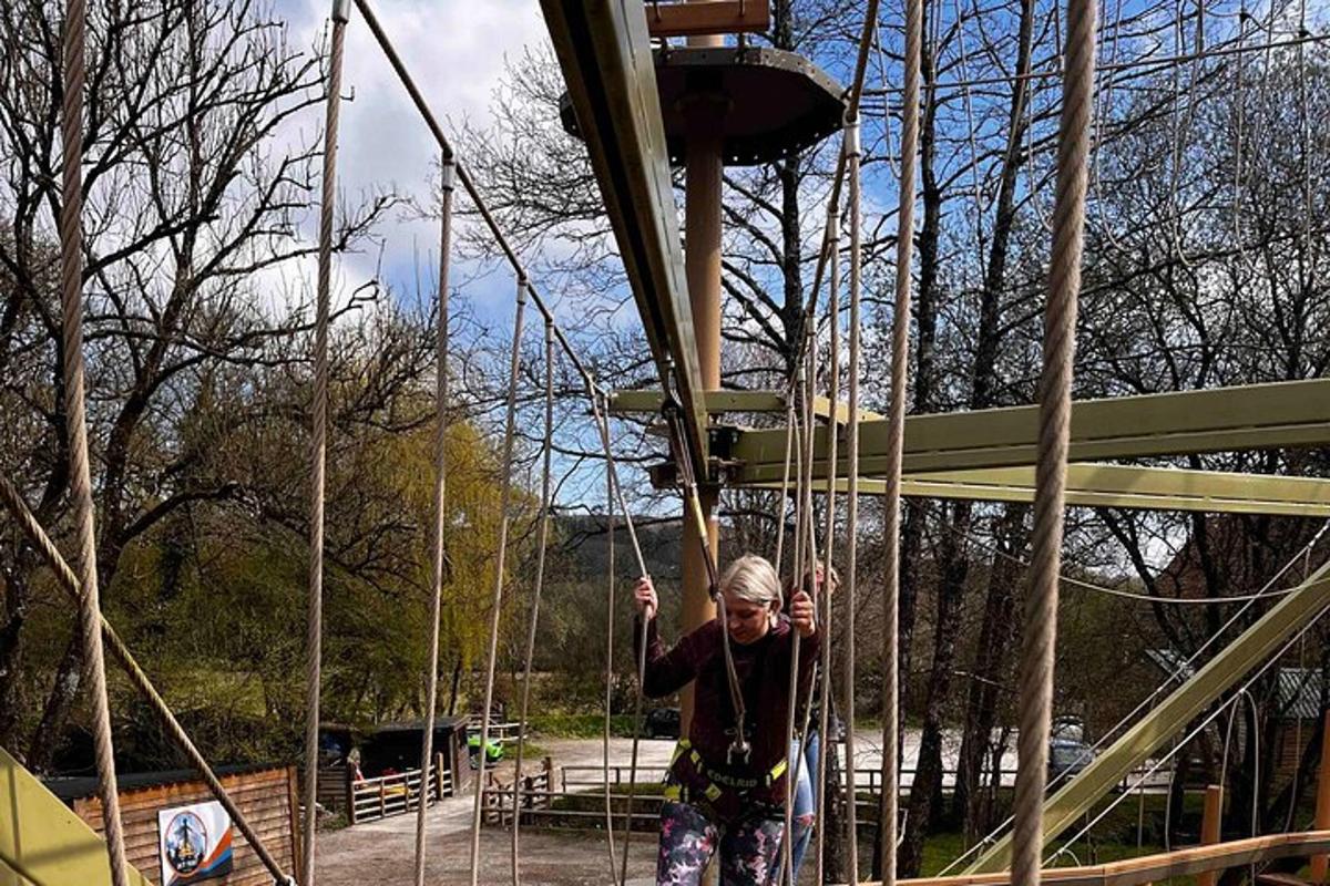a woman riding on a swing in a park