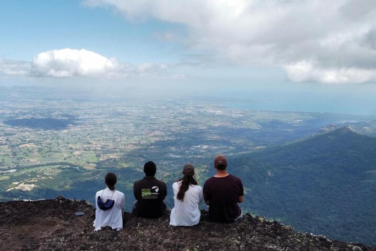 a group of people sitting on top of a mountain