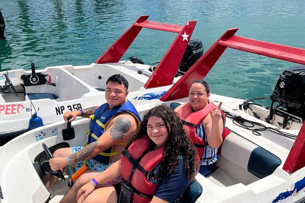 three people sitting in a boat on the water