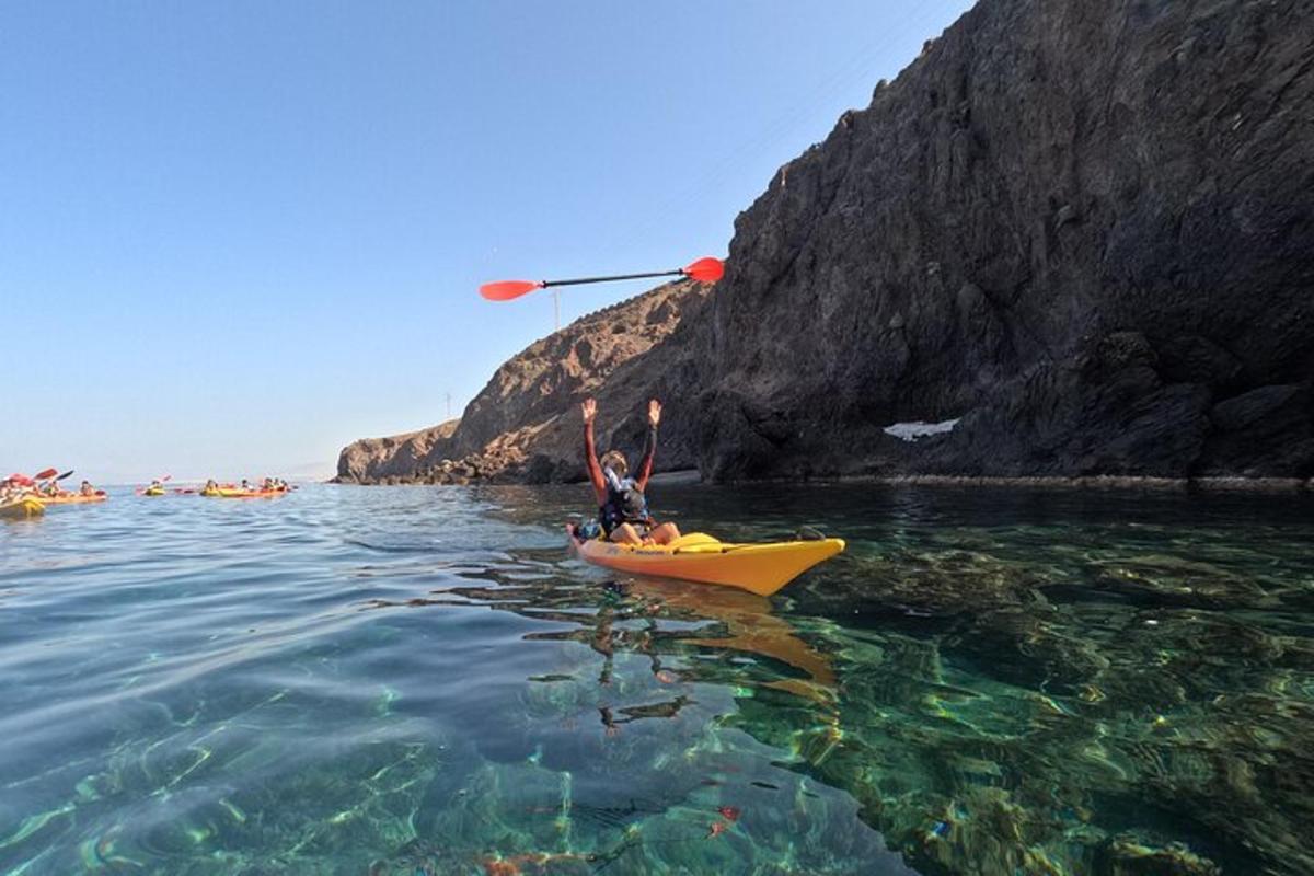 a person in a yellow kayak in the water