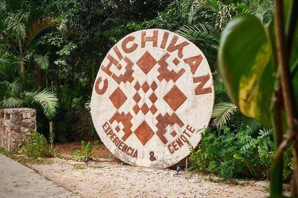 a large stone sign sitting in a garden