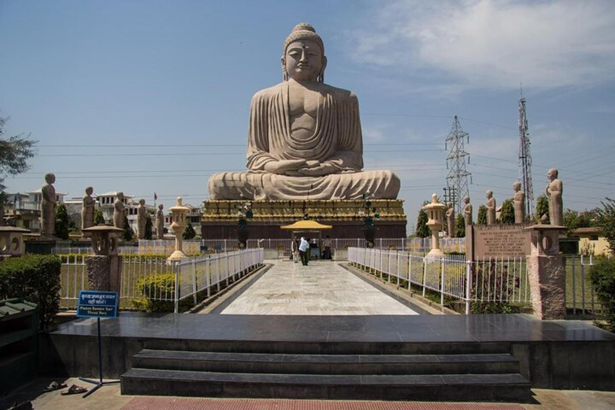 a large statue of a buddha on a bridge