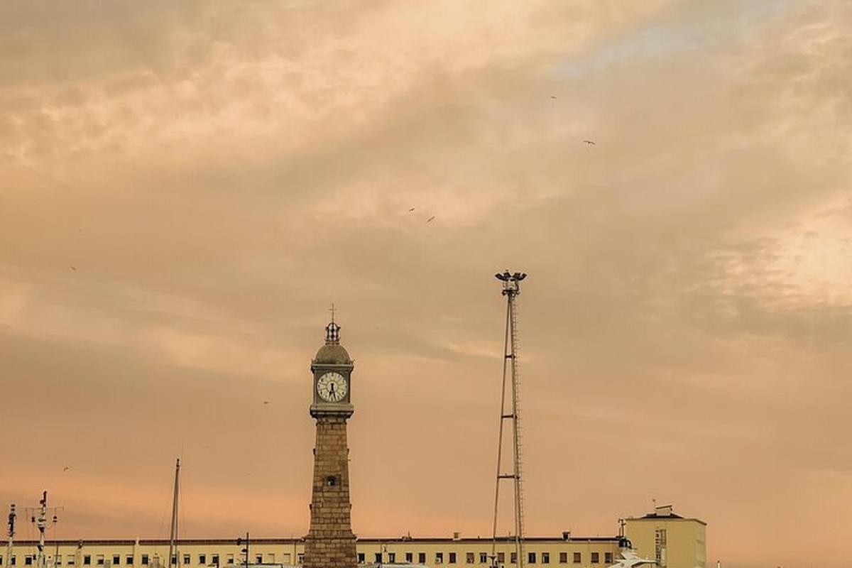 a clock tower in front of a building with a sky