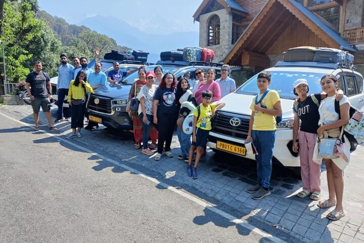 a group of people standing in front of a car