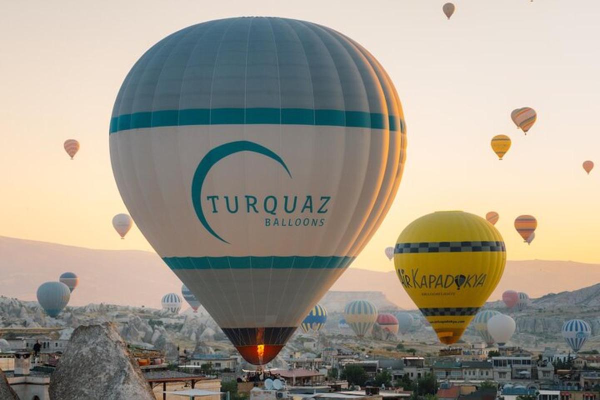 a group of hot air balloons flying over a city