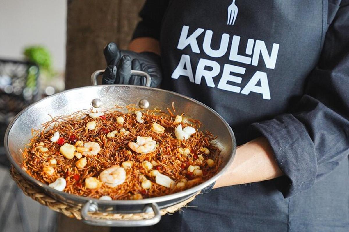 a person is holding a pan of food
