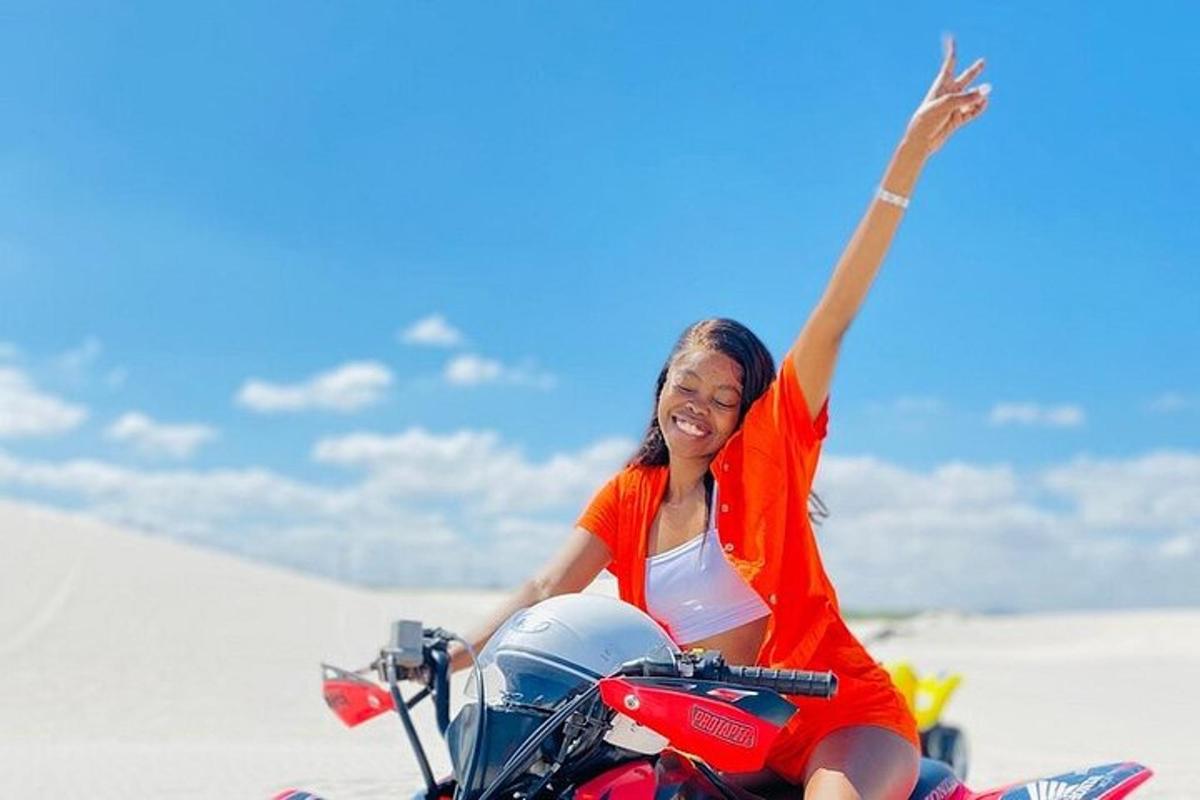 a woman sitting on a motorcycle in the sand
