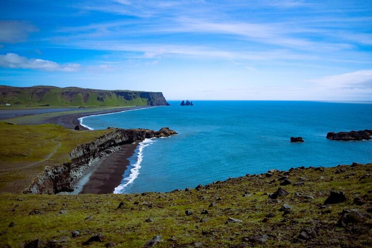 a view of a beach with the ocean and rocks