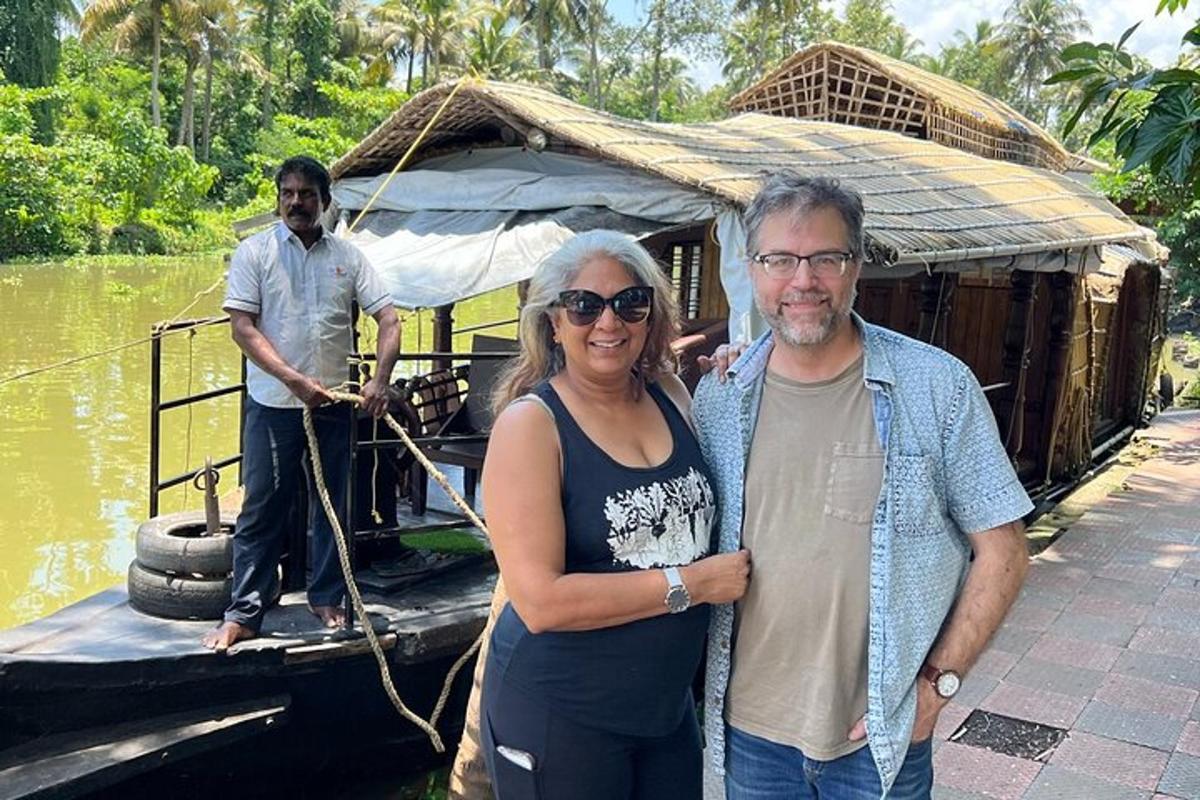a man and a woman standing on the back of a boat
