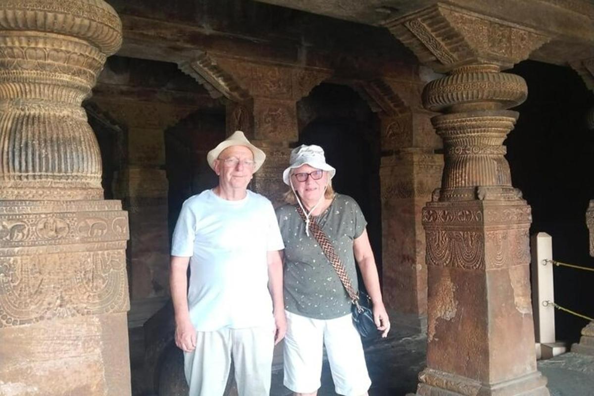 two older people standing next to each other in a building
