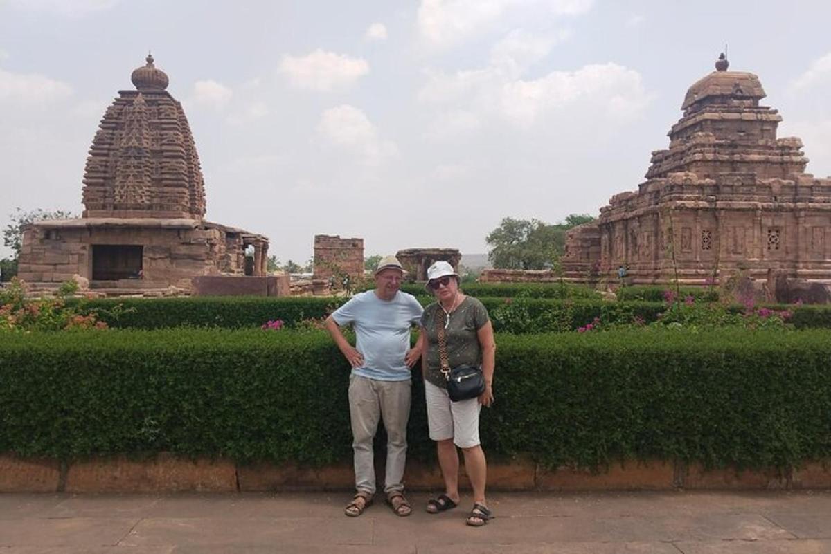 a man and a woman standing in front of a temple