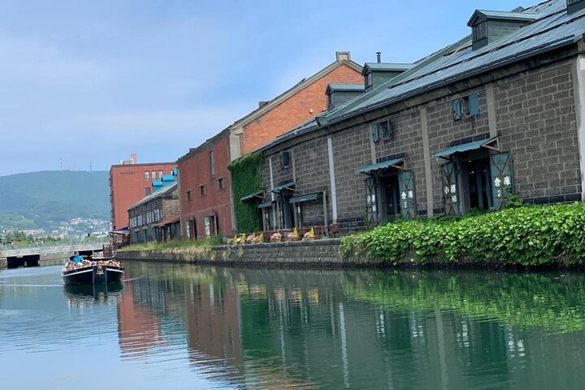a small boat in a river next to a building