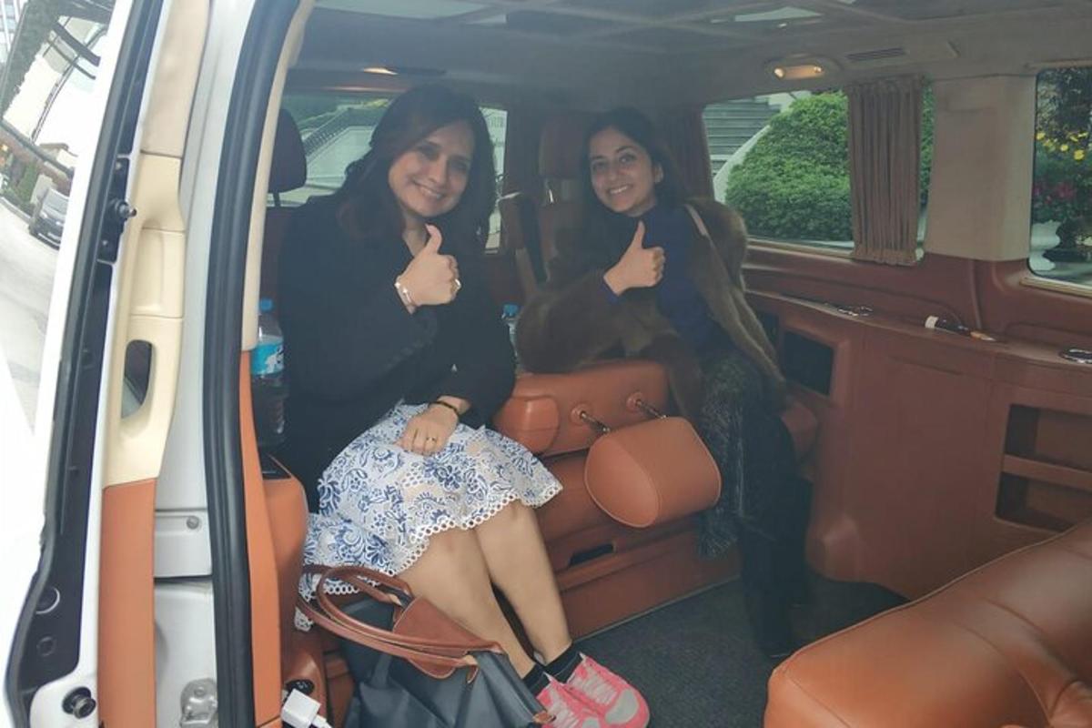 two women sitting in the back of a van