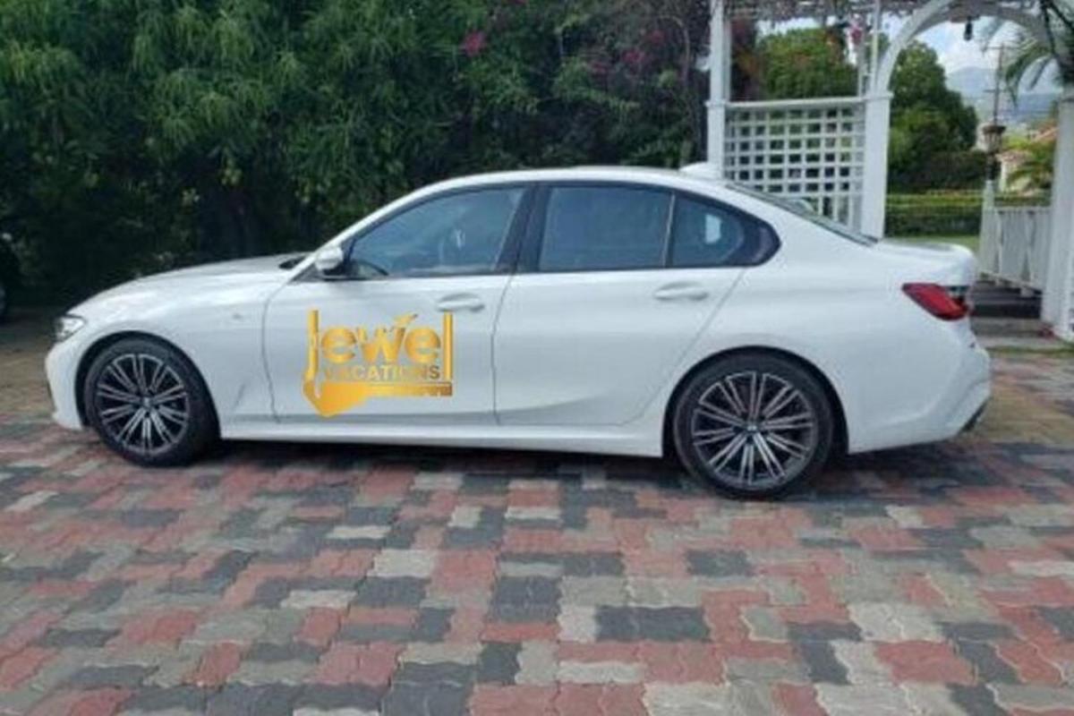 a white car parked on a brick driveway