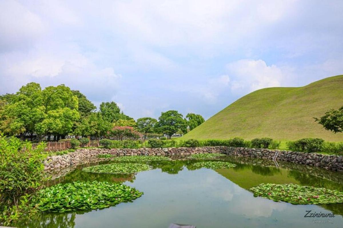 a bridge over a river with grassy hills
