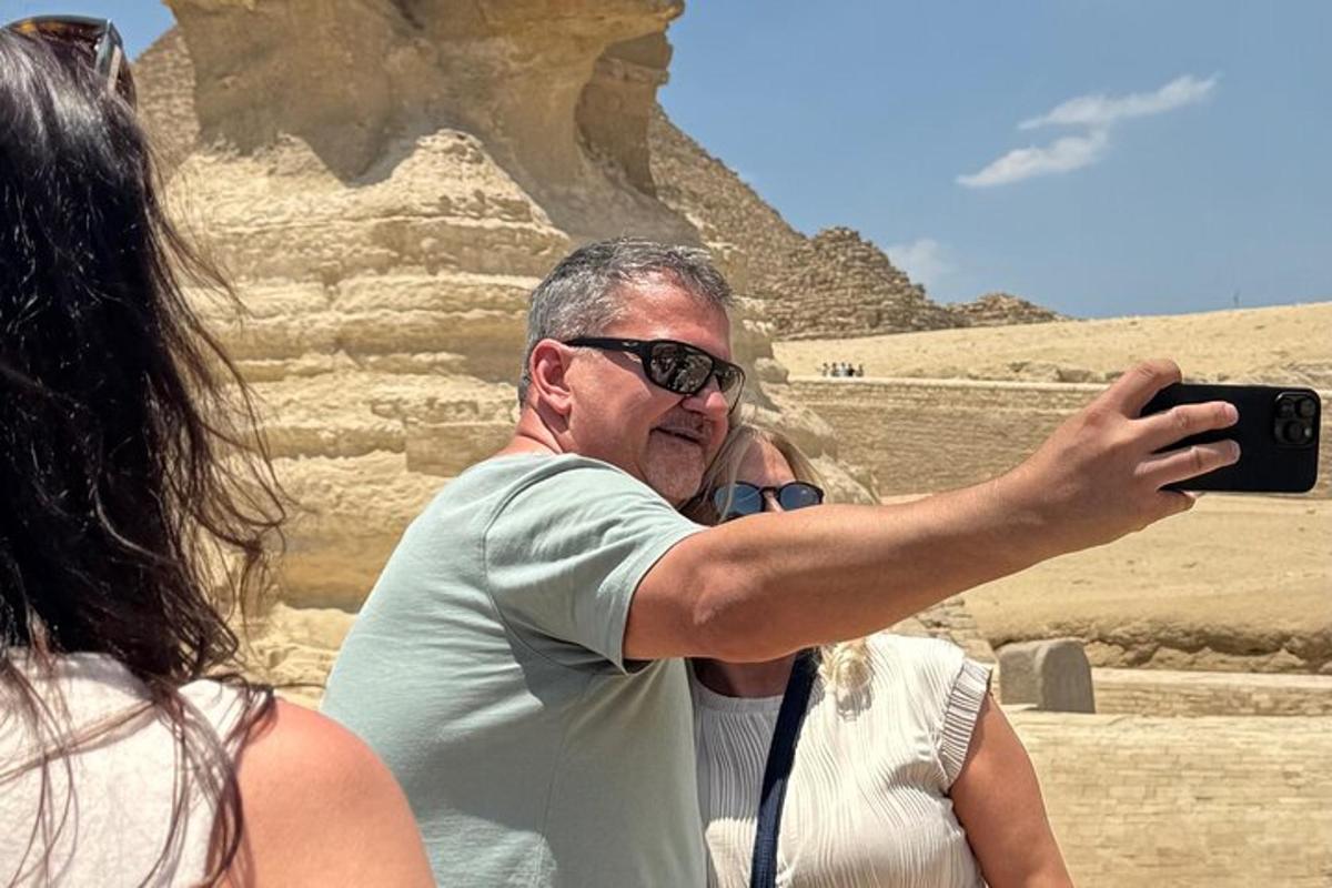 a man taking a picture of the pyramids