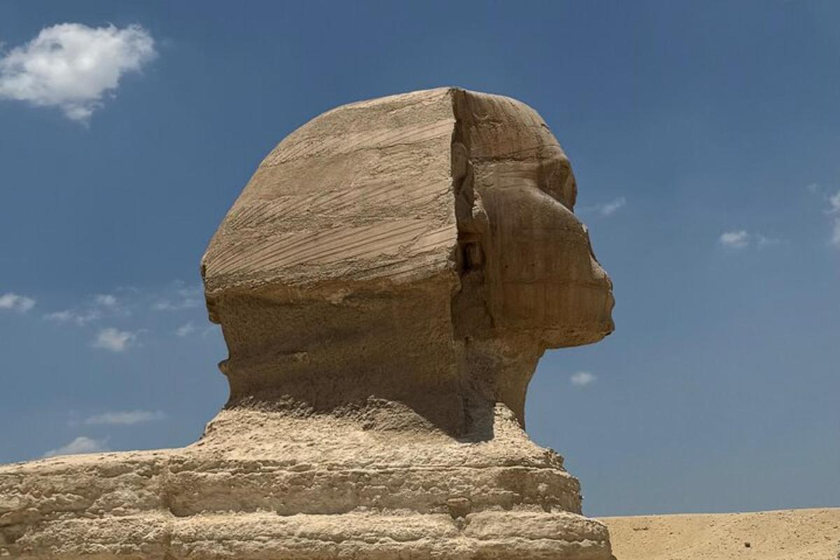 a statue of a head on top of a rock