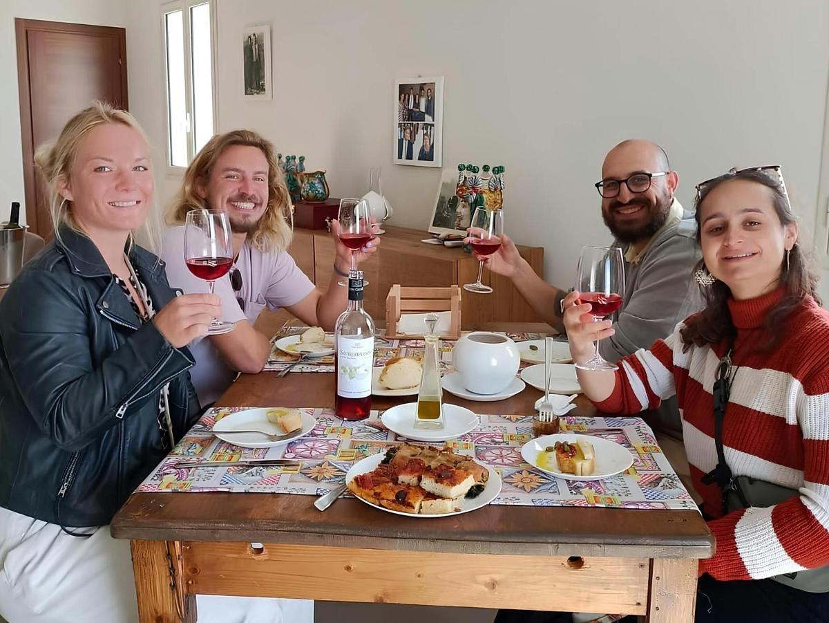 a group of people sitting around a table with wine glasses