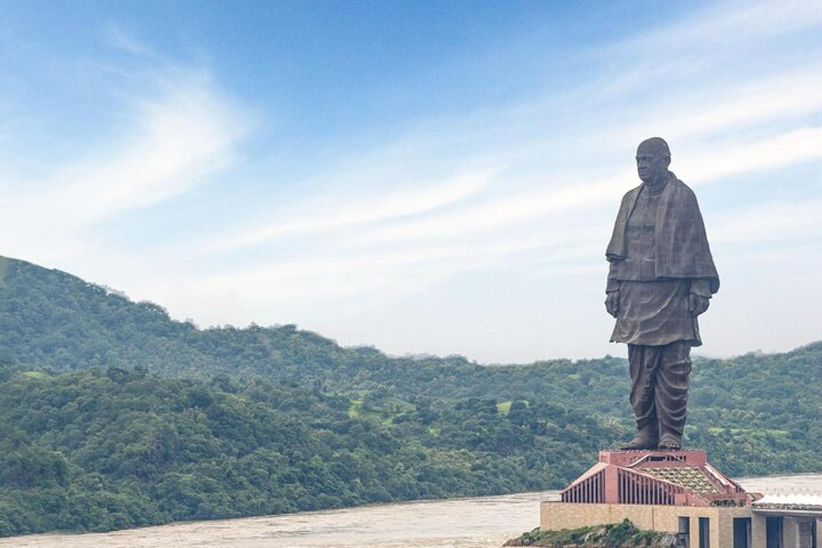 a statue of a man standing on top of a building