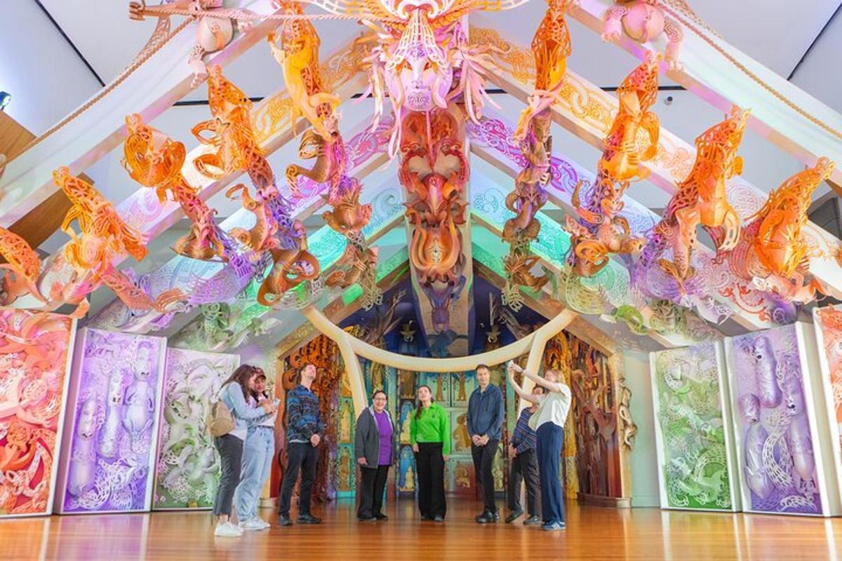 a group of people standing in front of a chandelier