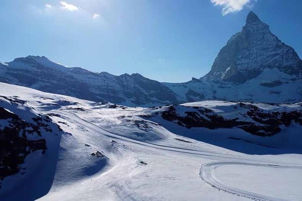 a snow covered mountain with a road in the distance