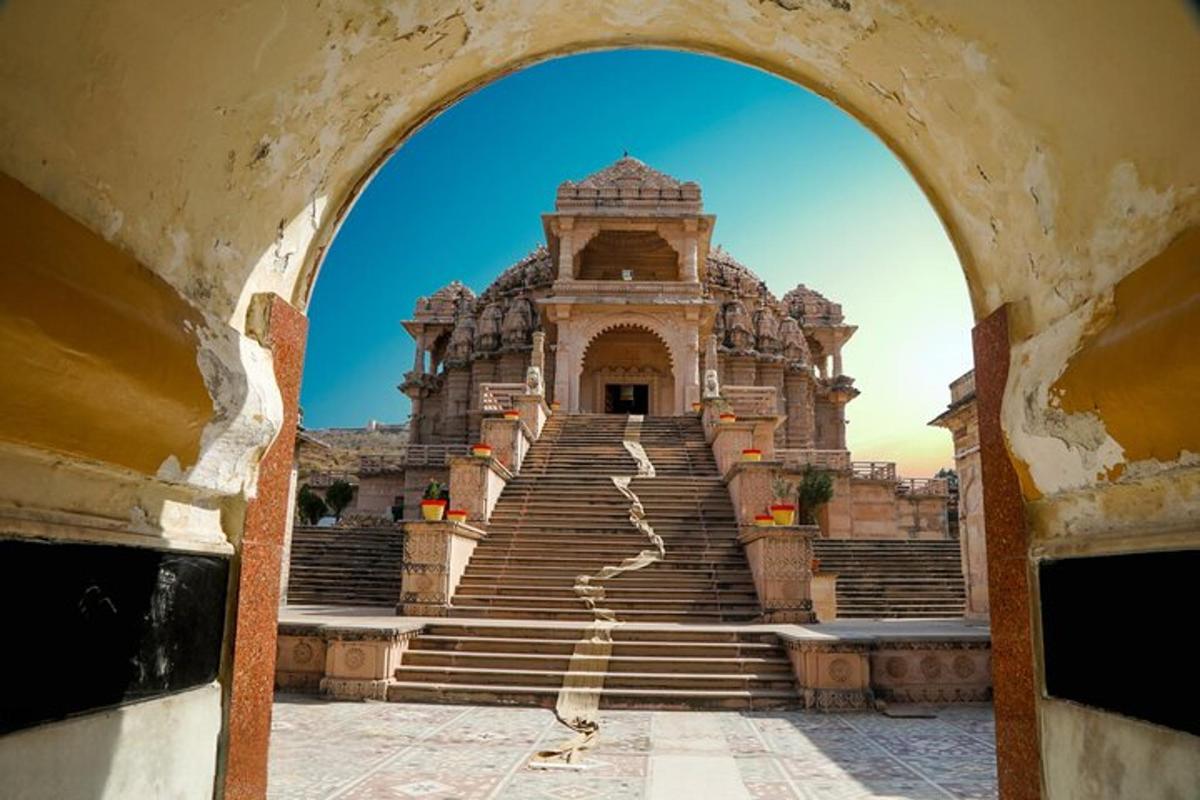 an archway leading to a large building with stairs