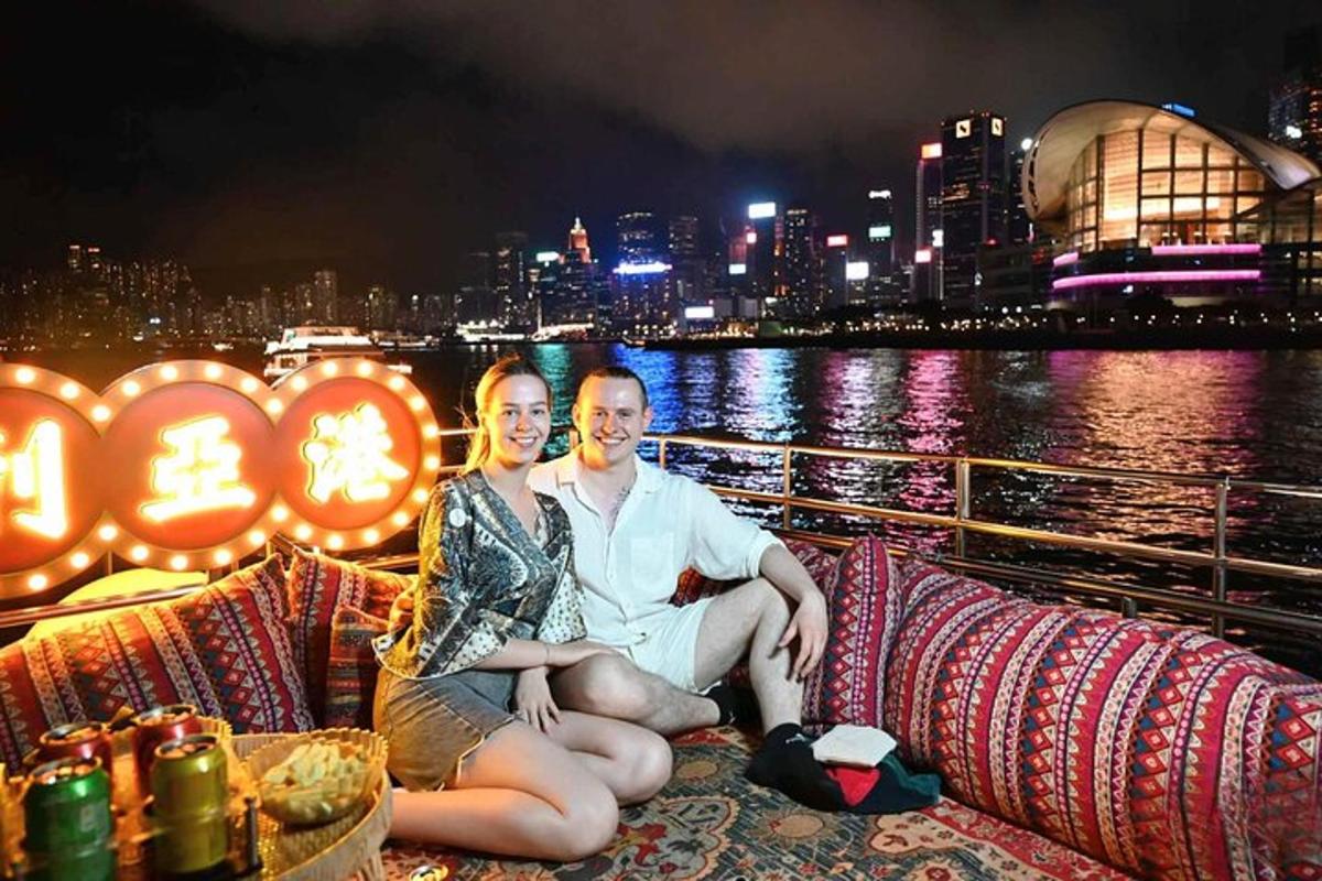 a man and woman sitting on a cruise ship at night