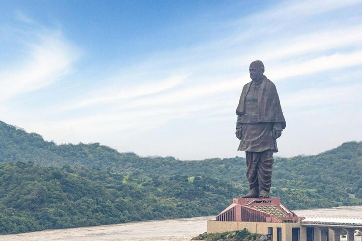 a statue of a man standing on top of a building