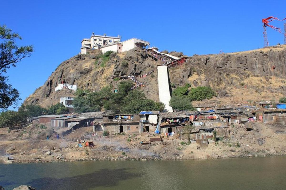 a village on a hill next to the water