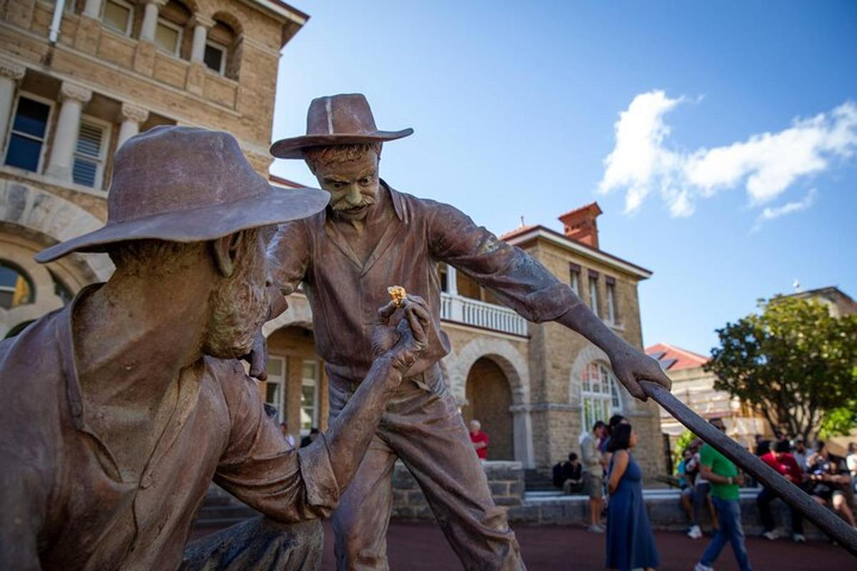 a bronze statue of two men in hats