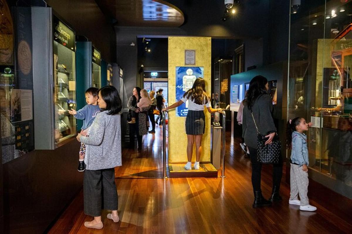 a group of people looking at a display in a museum