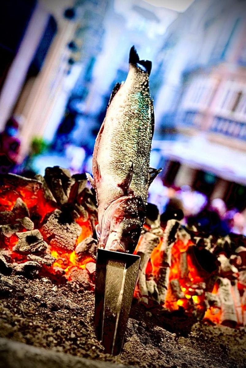 a dead fish sitting on top of a pizza