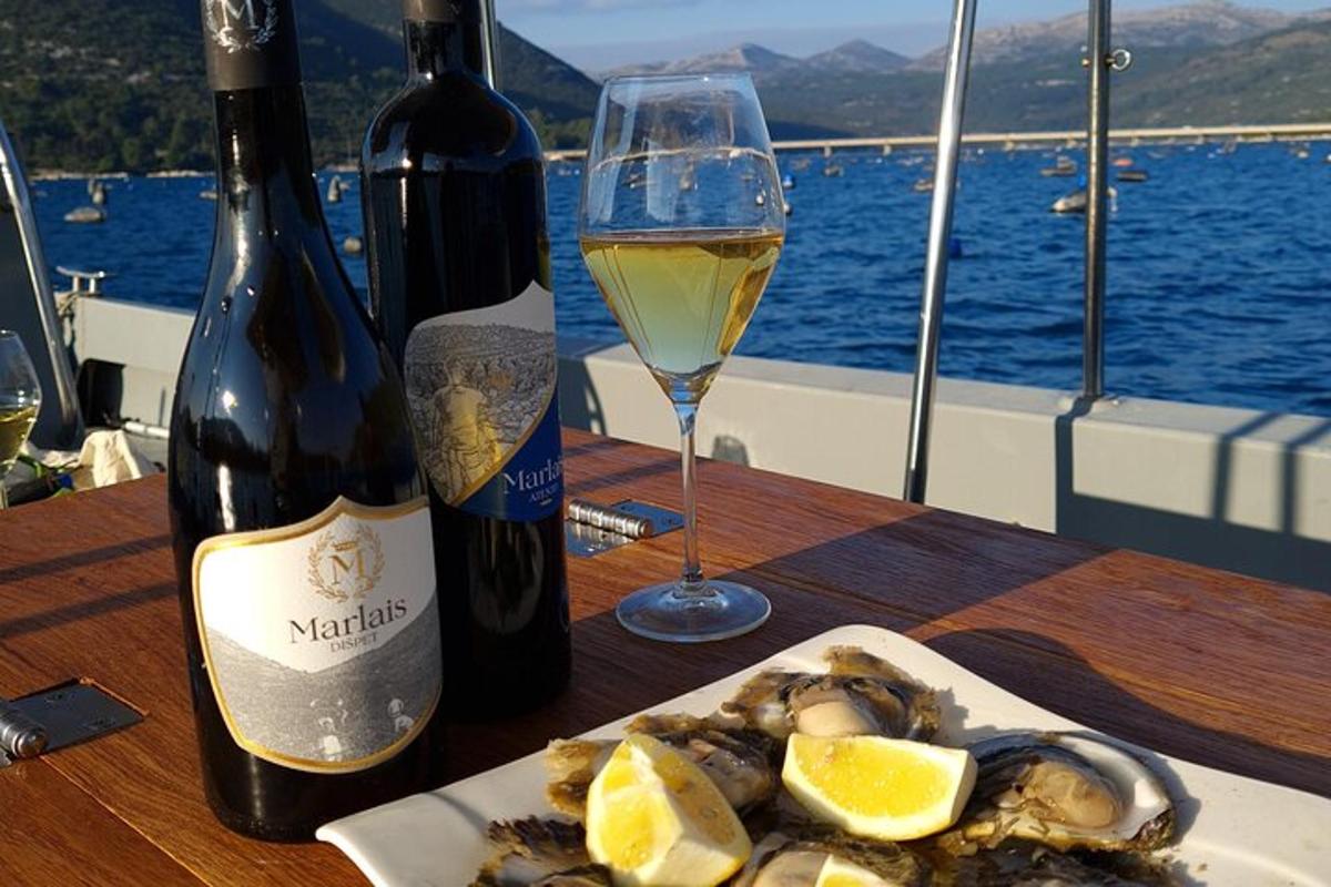 un tavolo con un piatto di cibo e un bicchiere di vino