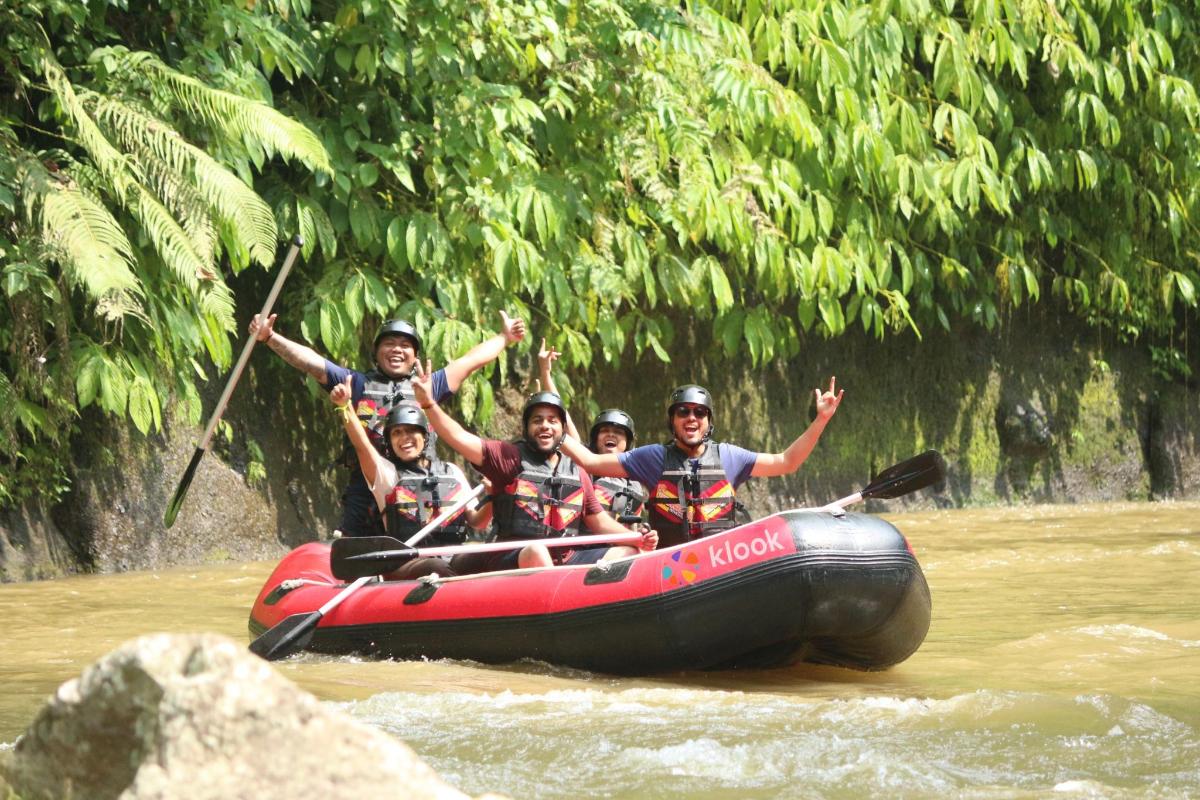 a group of people on a raft in the river