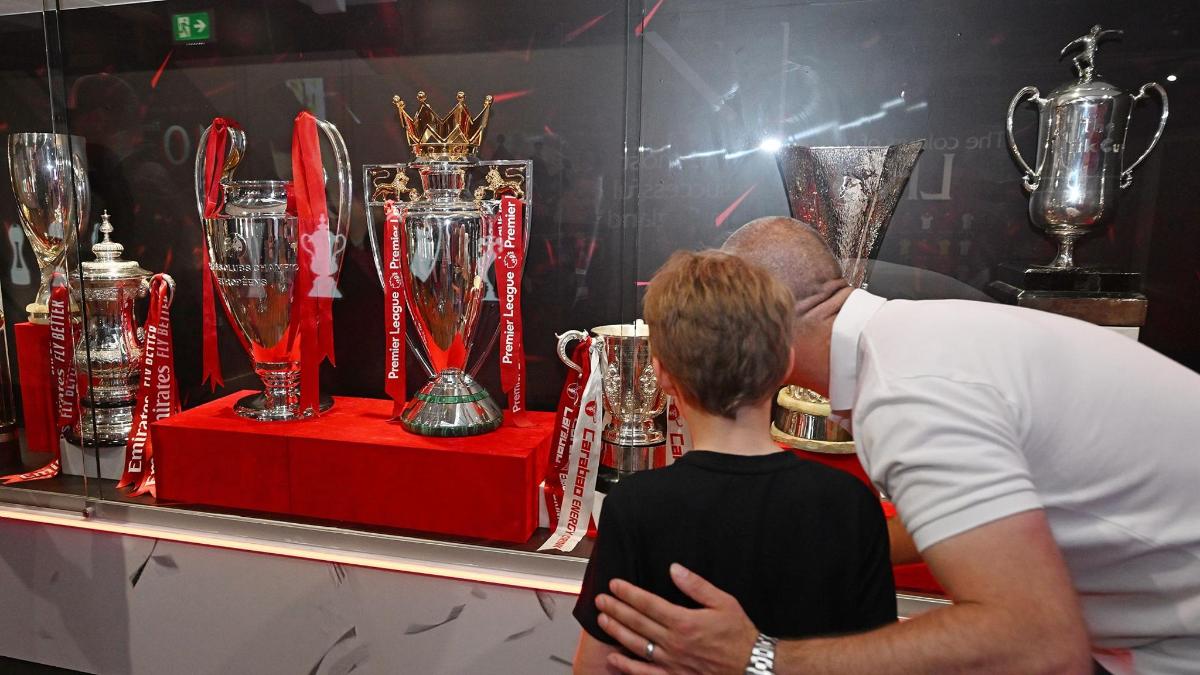 a man and a woman looking at a display of trophies