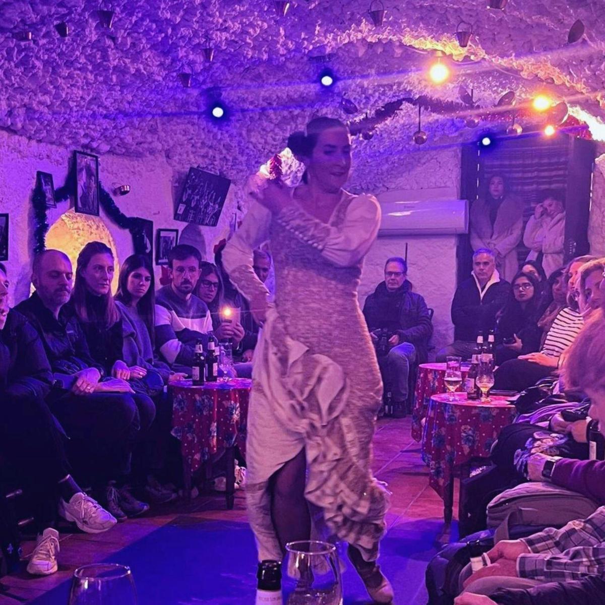 a woman in a dress walking on a dance floor