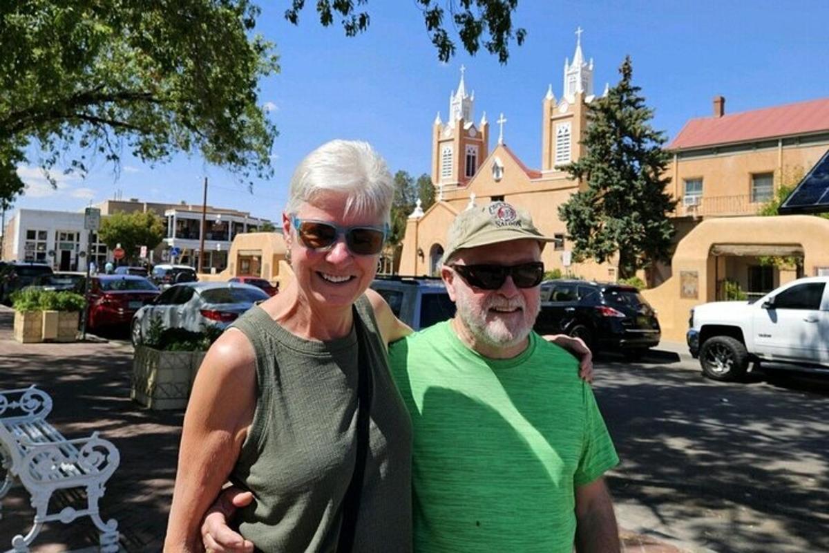 a man and a woman standing in a parking lot