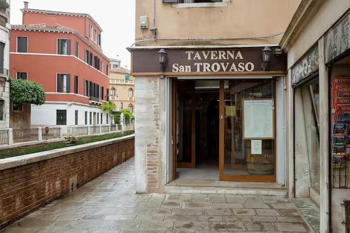 a building with a sign for a shop on a street