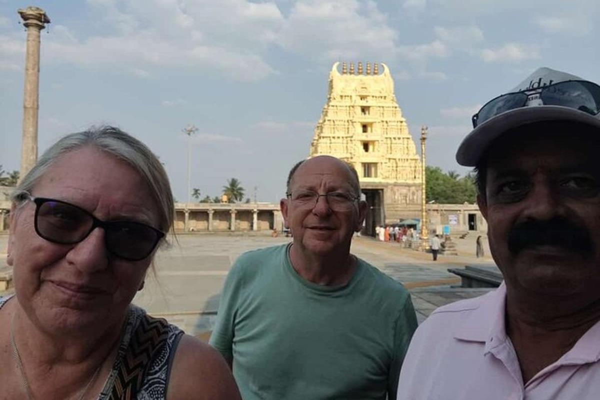 two men and a woman standing in front of a building
